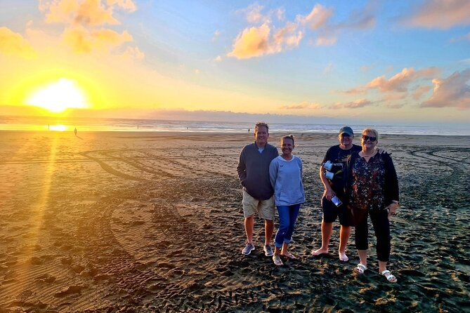 Romantic Auckland Sunset tour with Winery & Thermal pool - Muriwai Beach at sunset: black sand, Tasman Sea, and silhouettes