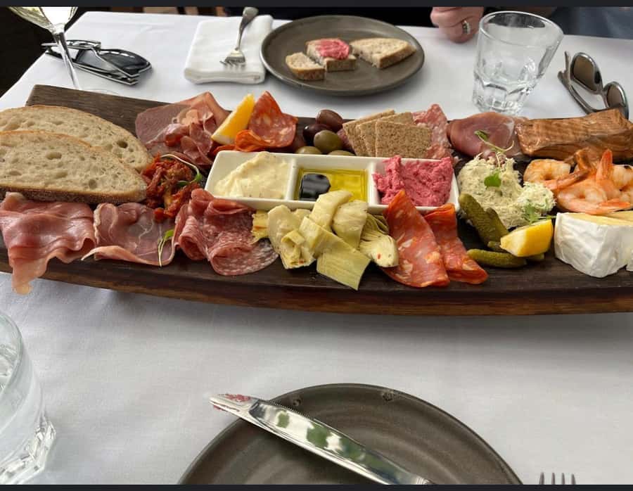 Waiheke: Scenic Taste and Graze Tour with Wine, Whisky, Beer - Mudbrick Restaurant and Vineyard: wine tasting with Rangitoto in view